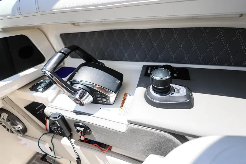 Slide: The Image of Control panel of 2022 Sea Ray SLX 310 Outboard boat, featuring joystick and throttle. - 29