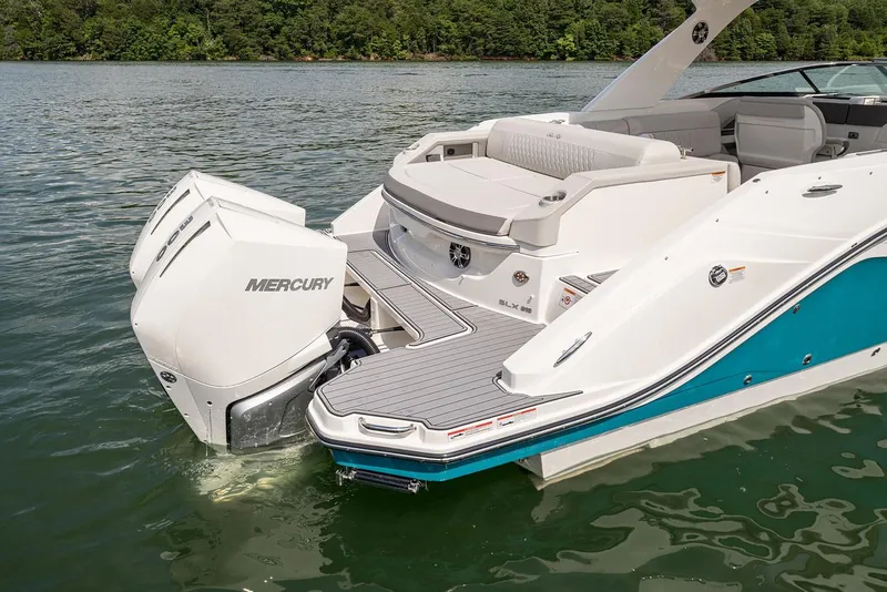 Slide: The Image of Manufacturer Provided Image: 2022 Sea Ray SLX 310 OB boat with twin Mercury outboard engines on a lake. - 3