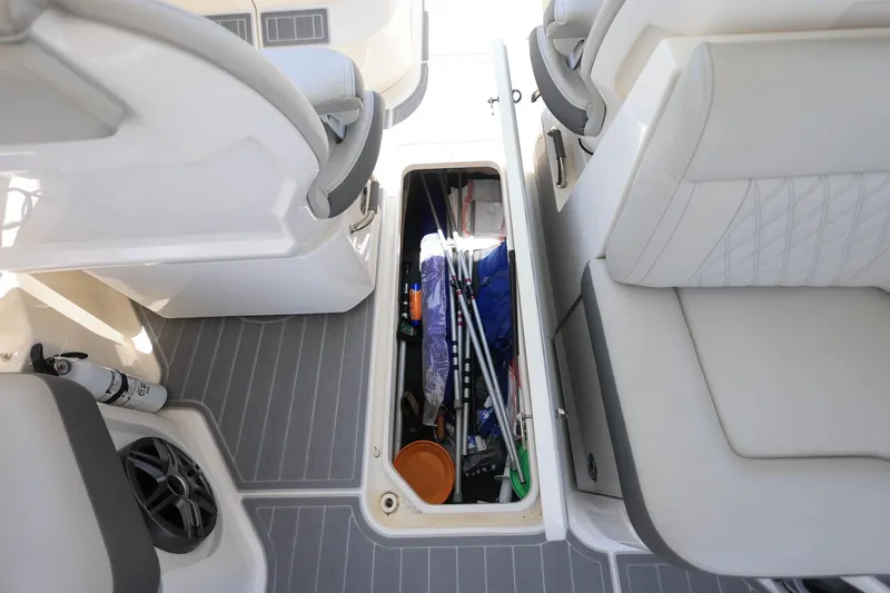 Slide: The Image of 2022 Sea Ray SLX 310 Outboard boat interior with open storage compartment. - 30