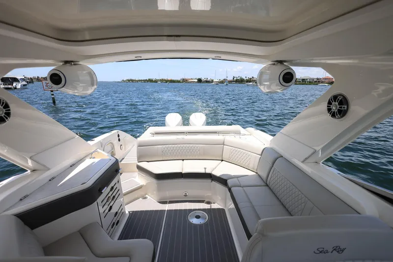Slide: The Image of 2022 Sea Ray SLX 310 Outboard boat interior with luxurious seating and water view. - 31