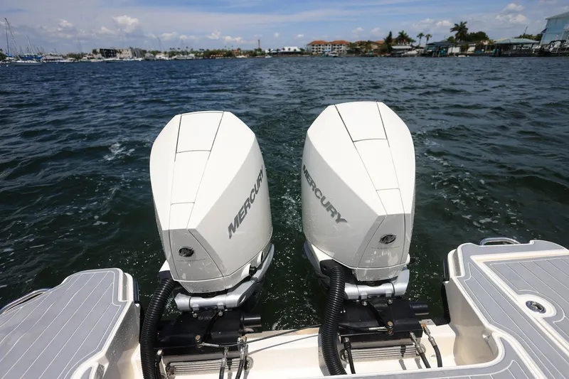 Slide: The Image of 2022 Sea Ray SLX 310 Outboard with twin Mercury engines on water. - 34