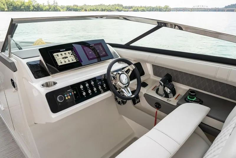 Slide: The Image of Manufacturer Provided Image: 2022 Sea Ray SLX 310 OB boat cockpit with modern controls and steering wheel. - 7