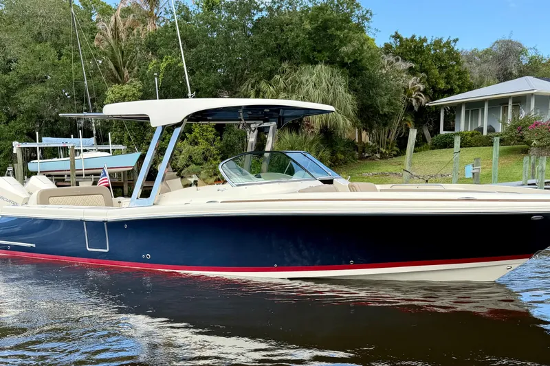 The Image of 2023 Chris-Craft Calypso 30 boat on water, surrounded by lush greenery. - 0