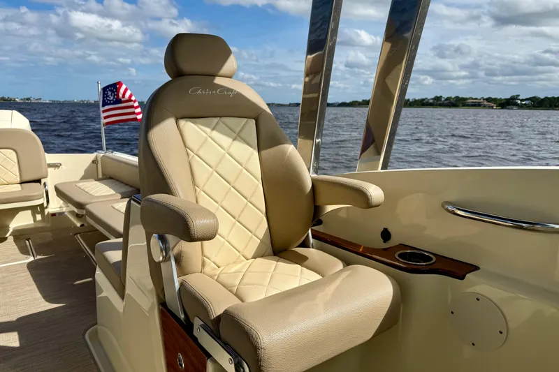 Slide: The Image of Luxurious seating on 2023 Chris-Craft Calypso 30 boat with American flag in background. - 10
