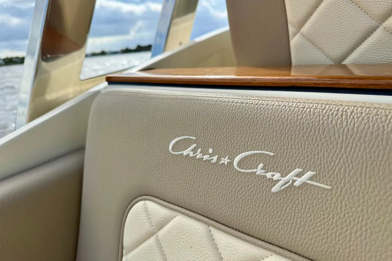 Slide: The Image of 2023 Chris-Craft Calypso 30 interior detail with elegant leather upholstery and logo. - 12