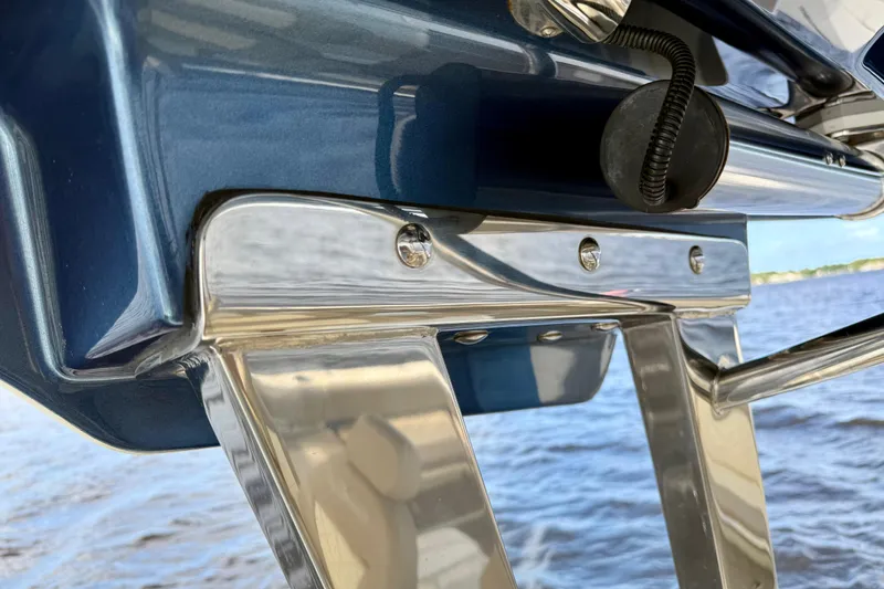 Slide: The Image of Close-up of 2023 Chris-Craft Calypso 30 boat's polished metal and blue hull detail. - 13