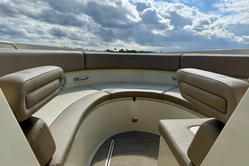 Slide: The Image of Luxurious seating on 2023 Chris-Craft Calypso 30 boat under cloudy sky. - 16