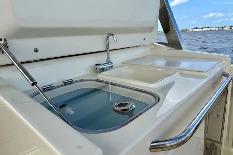 Slide: The Image of Outdoor sink and prep area on 2023 Chris-Craft Calypso 30 boat, with ocean view. - 17