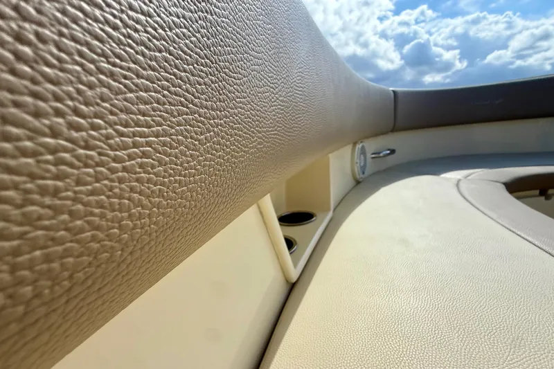 Slide: The Image of 2023 Chris-Craft Calypso 30 interior with beige leather upholstery and cup holders. - 19