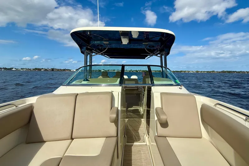 Slide: The Image of 2023 Chris-Craft Calypso 30 boat interior with beige seating on open water. - 20