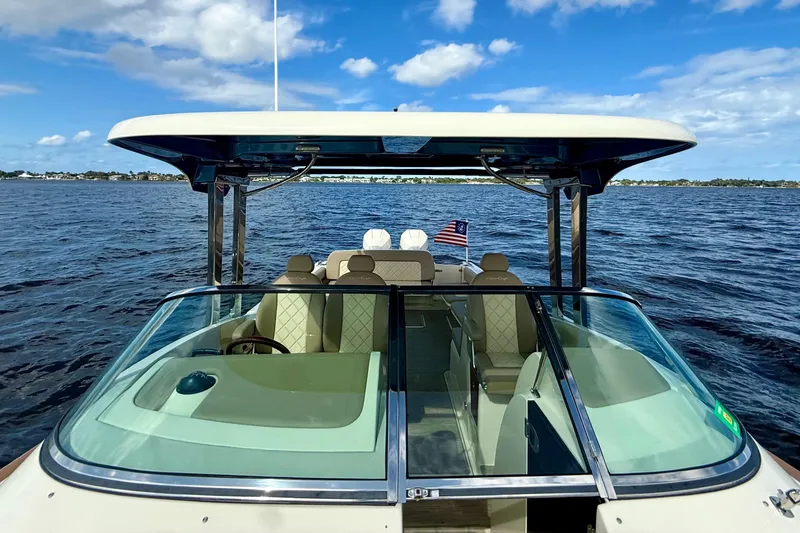 Slide: The Image of 2023 Chris-Craft Calypso 30 boat on open water under blue sky. - 21