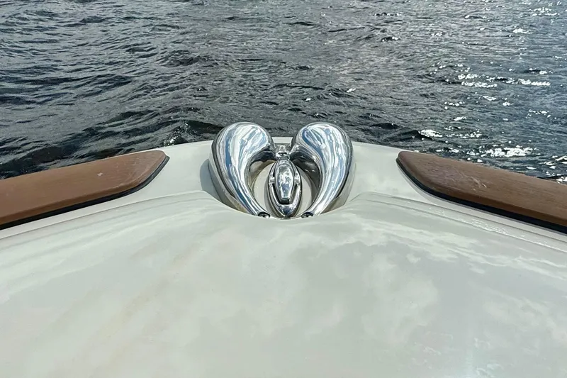 Slide: The Image of Bow of 2023 Chris-Craft Calypso 30 with polished metal fittings on water. - 24