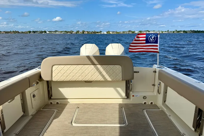 Slide: The Image of 2023 Chris-Craft Calypso 30 boat interior with American flag on open water. - 26