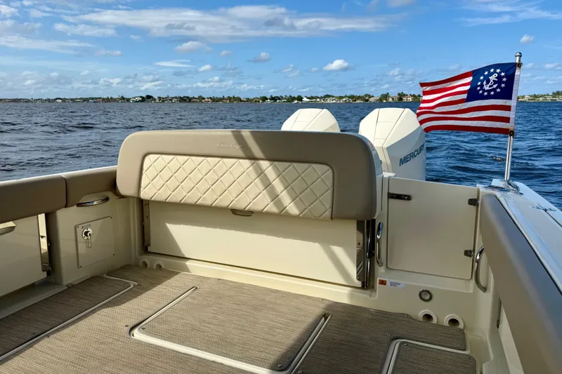 Slide: The Image of 2023 Chris-Craft Calypso 30 boat interior with American flag and Mercury engines. - 29