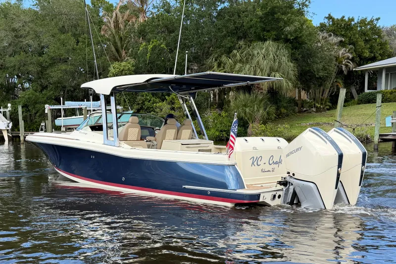 Slide: The Image of 2023 Chris-Craft Calypso 30 boat with dual Mercury engines on a serene waterway. - 3