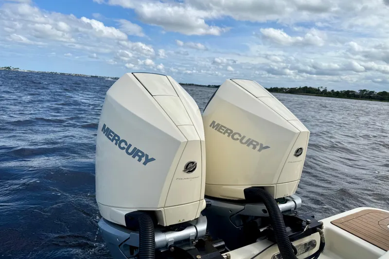 Slide: The Image of Twin Mercury outboard engines on a 2023 Chris-Craft Calypso 30 boat, cruising on open water. - 33
