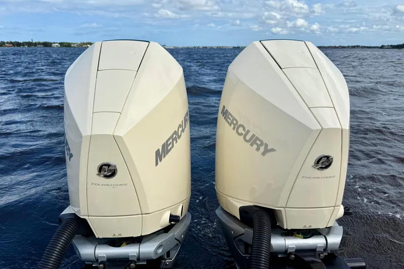 Slide: The Image of Twin Mercury outboard engines on a 2023 Chris-Craft Calypso 30 boat, cruising on open water. - 34