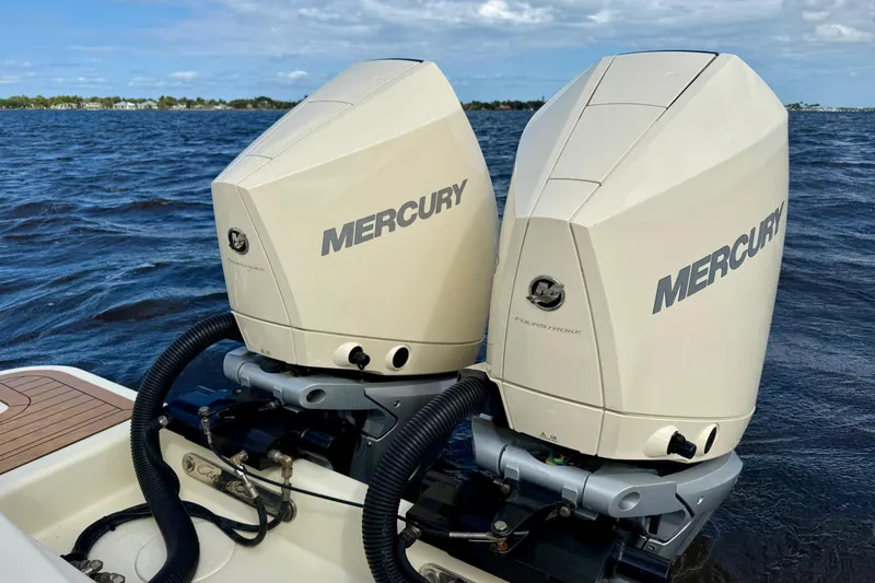 Slide: The Image of Twin Mercury outboard engines on a 2023 Chris-Craft Calypso 30 boat, on open water. - 35