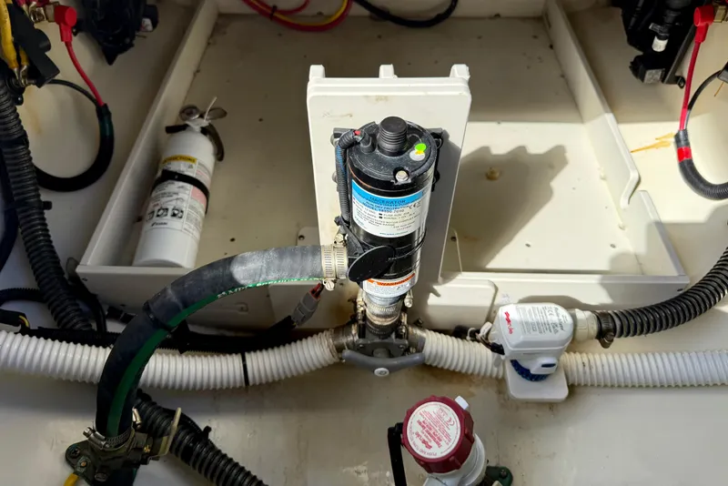 Slide: The Image of 2023 Chris-Craft Calypso 30 engine compartment with hoses and equipment. - 36