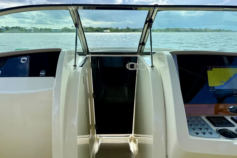 Slide: The Image of 2023 Chris-Craft Calypso 30 boat interior with open door and navigation display. - 8