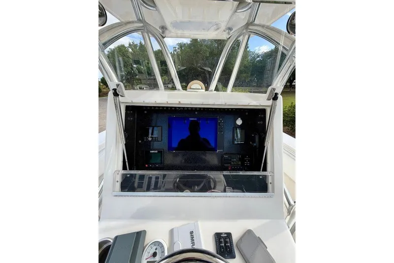 Slide: The Image of 2009 SeaHunter 29 Center Console dashboard with navigation equipment and steering wheel. - 10