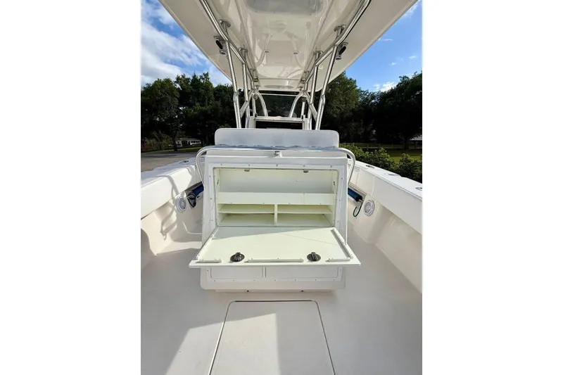 Slide: The Image of 2009 SeaHunter 29 Center Console boat with open storage compartment, showcasing spacious deck design. - 11