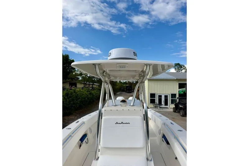Slide: The Image of 2009 SeaHunter 29 Center Console boat under clear blue sky. - 6