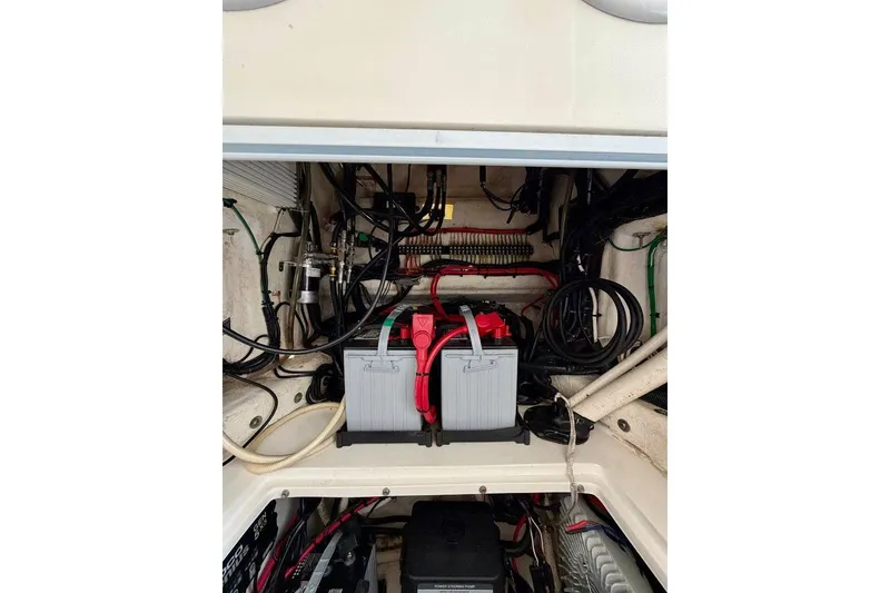 Slide: The Image of Engine compartment of a 2009 SeaHunter 29 Center Console with visible wiring and batteries. - 9