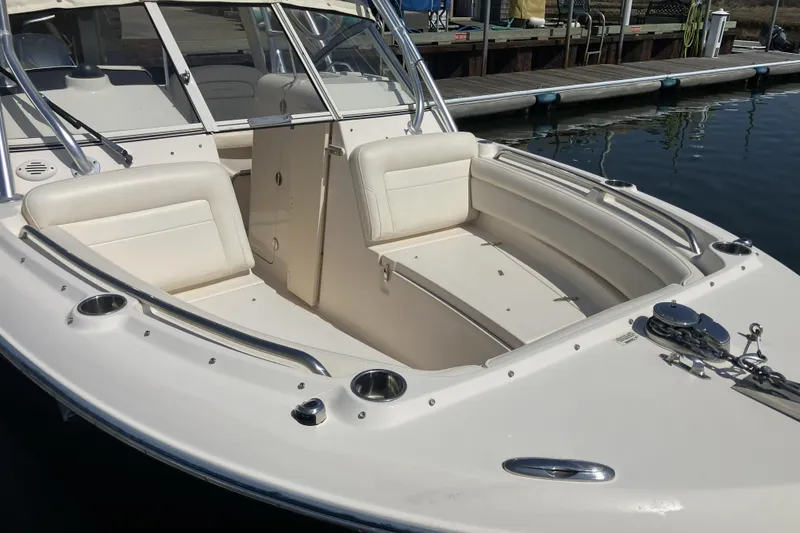 Slide: The Image of 2019 Grady-White Freedom 235 boat with spacious seating, docked at marina. - 10