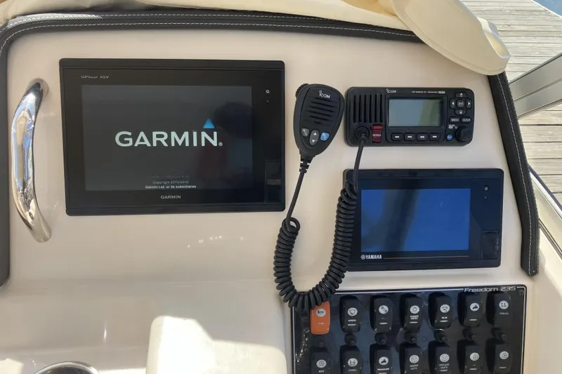 Slide: The Image of Control panel of 2019 Grady-White Freedom 235 with Garmin and Icom electronics. - 14