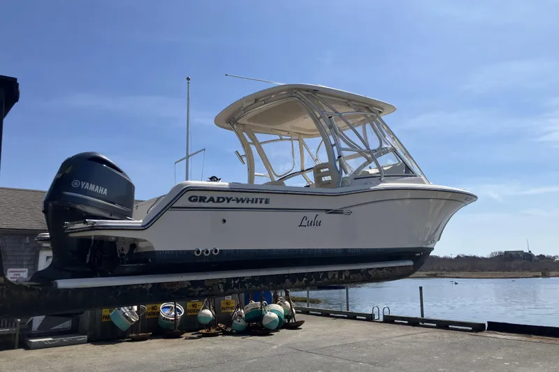 Slide: The Image of 2019 Grady-White Freedom 235 boat with Yamaha engine on dockside lift. - 21