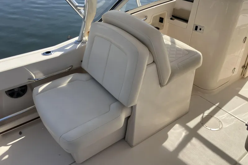 Slide: The Image of 2019 Grady-White Freedom 235 boat interior with luxurious white seating. - 6