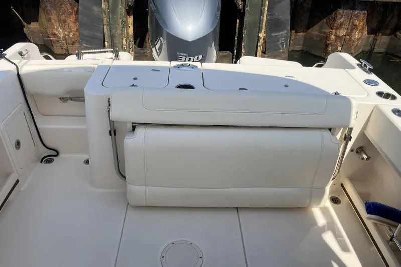 Slide: The Image of 2019 Grady-White Freedom 235 boat interior with white seating and Yamaha engine. - 7