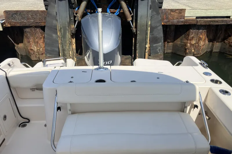 Slide: The Image of 2019 Grady-White Freedom 235 boat interior with seating and engine view. - 8