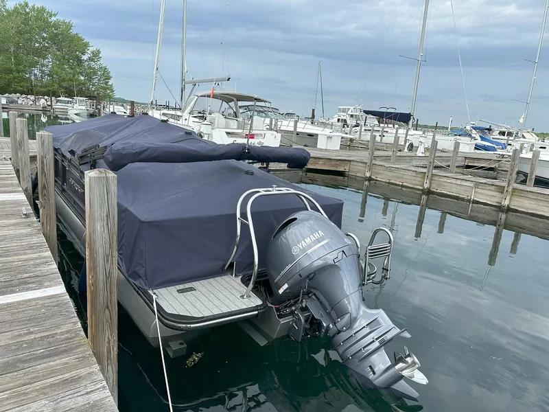 Slide: The Image of 2023 Starcraft SLS3 QDH boat with Yamaha engine docked. - 2