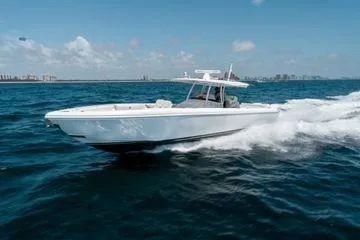 The Image of 2022 Intrepid 407 Nomad FE cruising on open water under clear skies. - 0