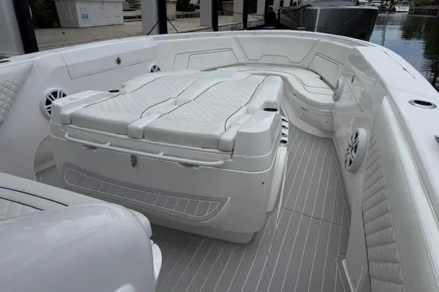 Slide: The Image of 2022 Intrepid 407 Nomad FE boat interior with white seating and sleek design. - 13
