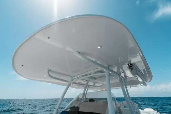 Slide: The Image of 2022 Intrepid 407 Nomad FE boat canopy under sunny blue sky. - 14