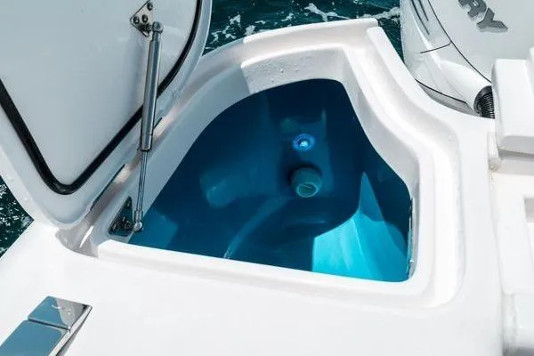 Slide: The Image of Livewell compartment on 2022 Intrepid 407 Nomad FE boat, open lid, blue interior. - 18