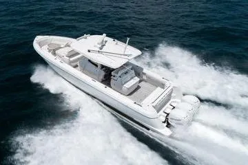 Slide: The Image of 2022 Intrepid 407 Nomad FE boat cruising on open water. - 22