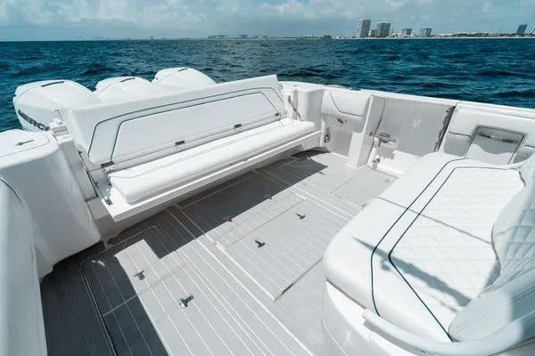 Slide: The Image of 2022 Intrepid 407 Nomad FE boat deck with luxurious seating, overlooking the ocean. - 3