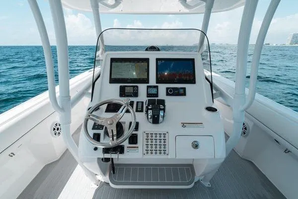 Slide: The Image of 2022 Intrepid 407 Nomad FE boat dashboard with steering wheel and navigation screens. - 7
