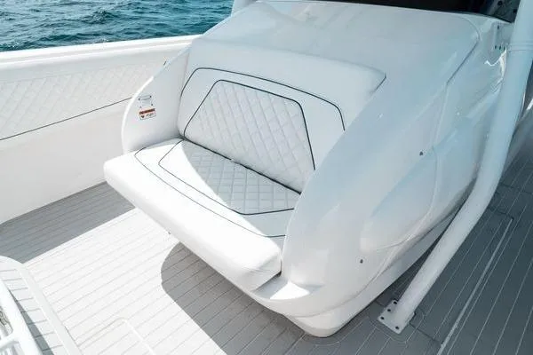 Slide: The Image of 2022 Intrepid 407 Nomad FE boat seat with white quilted upholstery on deck. - 9