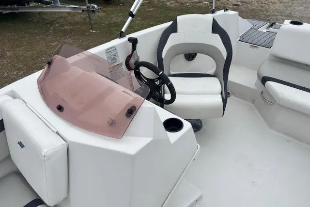 Slide: The Image of 2021 Starcraft SVX 171 OB boat interior with steering wheel and seating. - 13