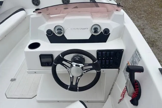 Slide: The Image of 2021 Starcraft SVX 171 OB boat dashboard with steering wheel and control panel. - 15