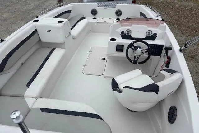 Slide: The Image of 2021 Starcraft SVX 171 OB boat interior with white seating and steering console. - 8