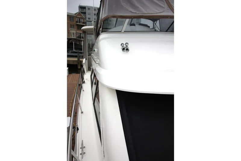 Slide: The Image of 2005 Cruisers Yachts 375 Motoryacht docked, showcasing sleek white exterior and modern design. - 10