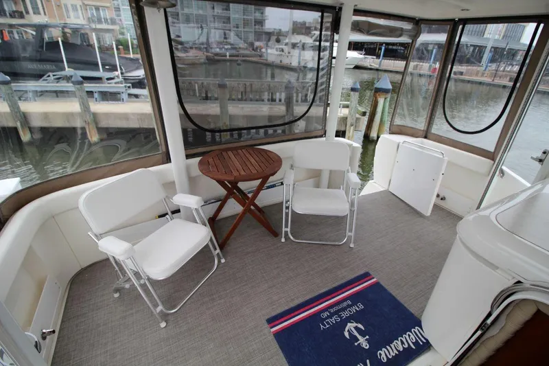 Slide: The Image of 2005 Cruisers Yachts 375 Motoryacht interior with chairs and table, dockside view. - 12