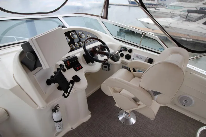 Slide: The Image of 2005 Cruisers Yachts 375 Motoryacht helm with steering wheel and control panel. - 15