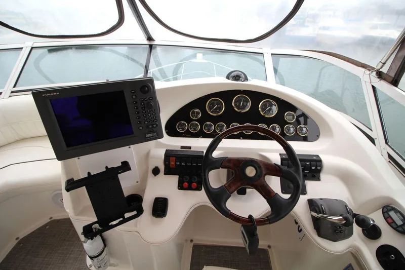 Slide: The Image of Helm of 2005 Cruisers Yachts 375 Motoryacht with steering wheel and navigation instruments. - 16